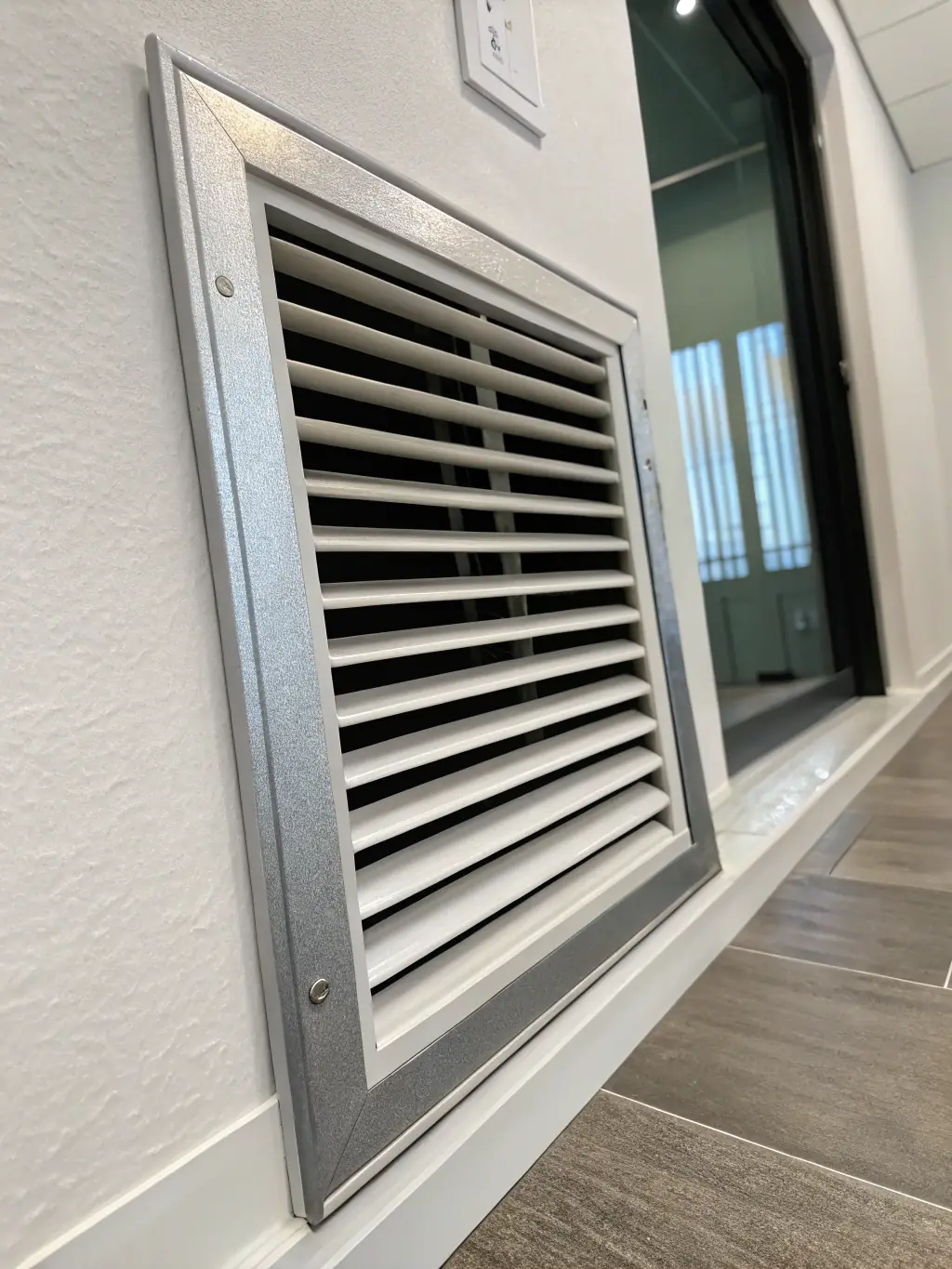 An image showcasing the studio's air conditioning system, with vents and temperature controls visible. The scene should evoke a feeling of comfort and climate control.