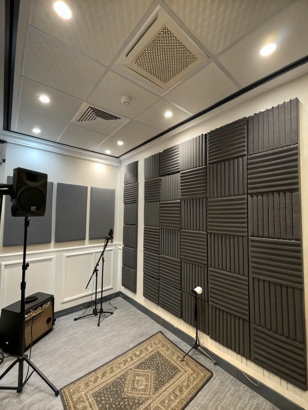 A close-up shot of a studio wall demonstrating soundproofing, with acoustic panels clearly visible. The image should convey a sense of quiet and professional sound quality.